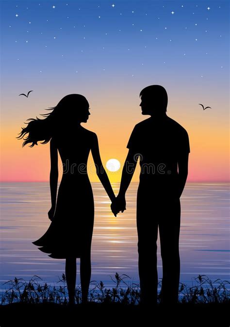 Sunset Silhouettes Of Man And Woman Standing And Holding Hands At