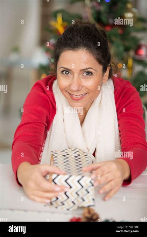 Christmas Woman Cutting Wrapping Paper Stock Photo Alamy