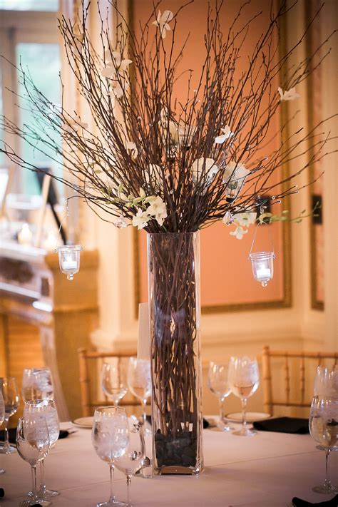 Tall Centerpieces With Branches And White Flowers