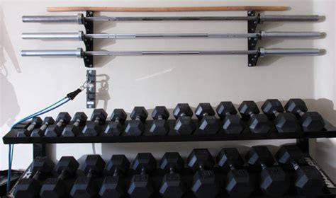 Create a shelf that is the correct width for your dumbbells, that is strong enough to hold them all up. Space Saving DIY Barbell Rack / Bar Storage