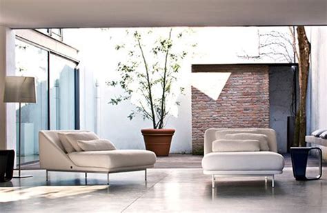 A Living Room Filled With White Furniture Next To A Tall Plant In A