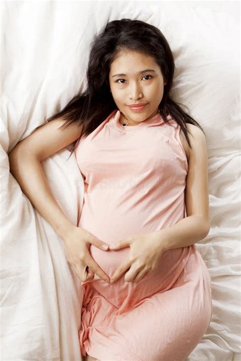 Pregnant Asian Woman On A Comfortable Bedroom Stock Image Image Of