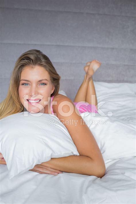 Cheerful Blonde Lying On Her Bed Smiling Stock Photo Royalty Free