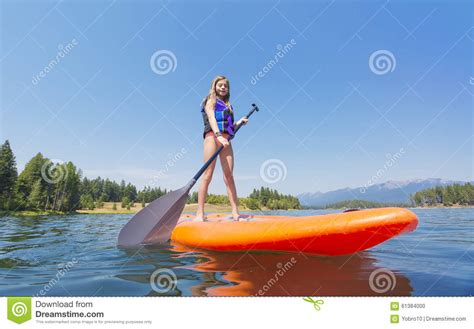 Child On A Stand Up Paddle Board On A Beautiful Mountain