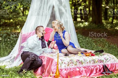 A Couple On Bed In Meadow Stock Photo Download Image Now Undressing