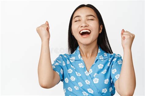Relieved Happy Asian Girl Fist Pump Laughing And Smiling With