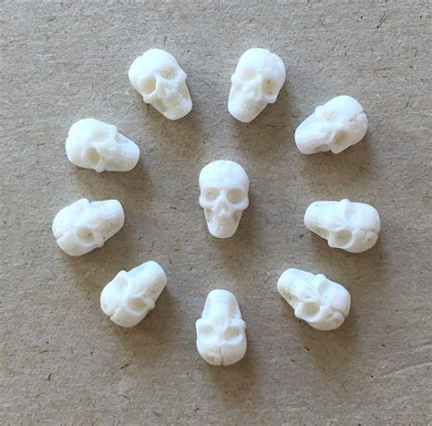 There Are Eight Small White Skulls On The Table