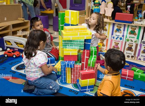 Preschool Children Playing With Blocks On The Floor Stock Photo
