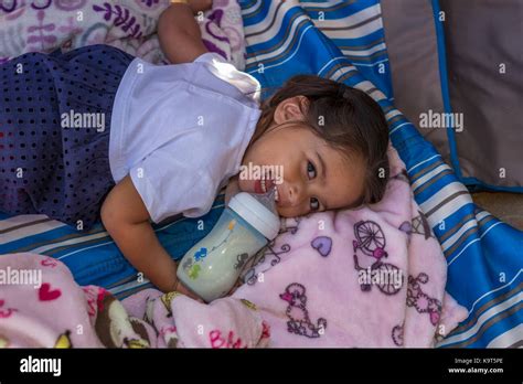 1 One Hispanic Girl Baby Girl Drinking From Baby Bottle
