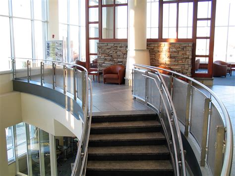 Wooden handrails adding a modern touch to a handrail project. inox™ Photo Gallery | HDI Railing Systems