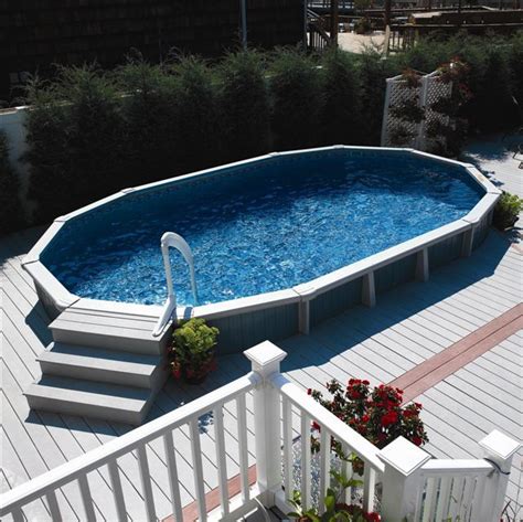 This above ground pool has a beautiful wooden deck and fence surrounding the entire pool, making it look very much. oval above ground pool decks | Premier Aluminum Above ...