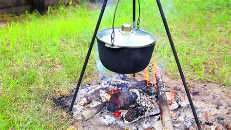 Some fires are better for cooking than others while different styles are better for heating or signaling. Cooking in Pot Hanging Above Stock Footage Video (100% ...