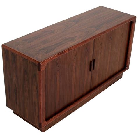 Dyrlund's clientele can be found worldwide. Rosewood Tambour Cabinet by Dyrlund from Denmark at 1stdibs