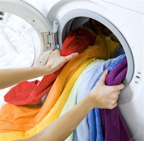 Woman Taking Color Clothes From Washing Machine Stock Photo By