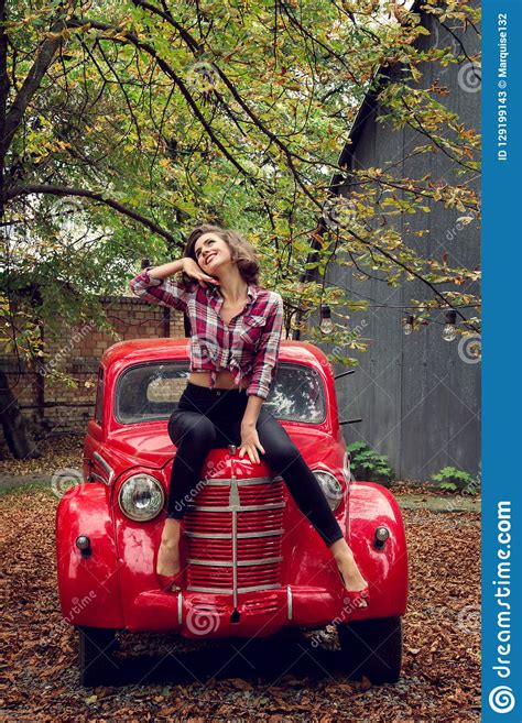 Pin Up Girl Posing Sitting On A Red Russian Retro Car