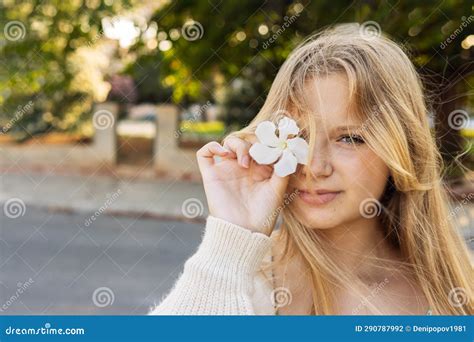 portrait of a teenage girl of european blonde hair stands on the