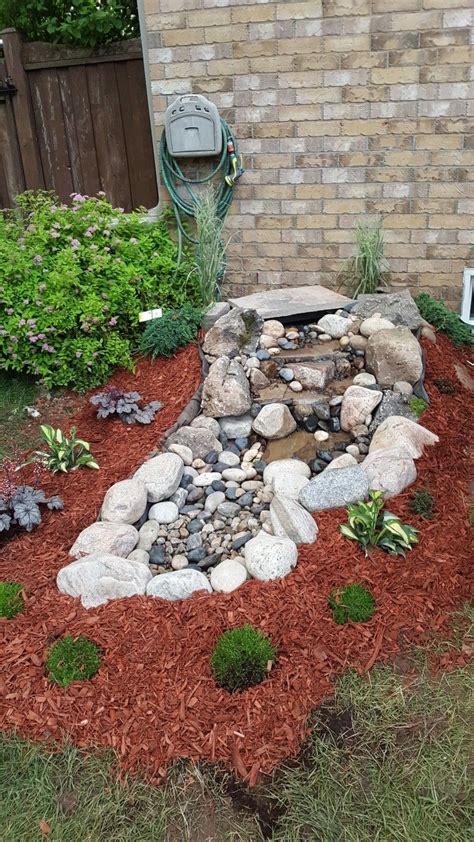 A pond fountain adds tranquility and visual appeal to your home. Small backyard pondless water feature | Pondless water features, Pond fountains, Water features