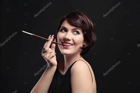 Woman Smoking With Cigarette Holder — Stock Photo © Belchonock 148526845