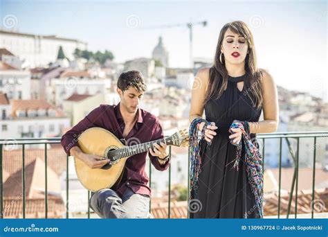 Beautiful Fado Singer Performing With Handsome Portuguese Guitar Stock