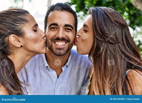 hispanic women kissing happy man standing at the city stock image image of friends people