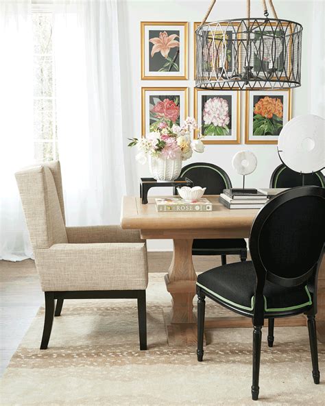 A Dining Room Table With Chairs And Pictures On The Wall