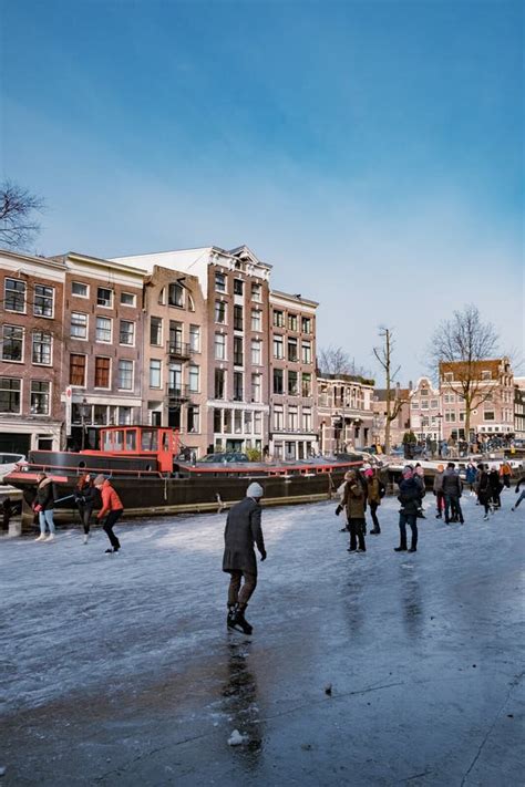 ice skating on the canals in amsterdam the netherlands in winter frozen canals in amsterdam