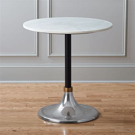 Hard, sculptural rock strikes a strong statement when unbroken—marble slab dining tables and cut marble accent tables look like functional sculptures in the living room. hackney marble cocktail table | CB2