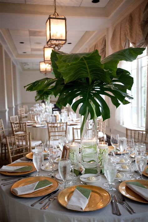 Decorative set with palm tree in a vase. giant palm leaves as centerpiece, dramatic yet cost ...