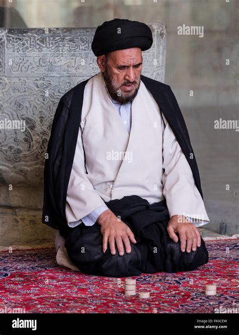 Shia Muslim Mullah In Turban And Gown Seated At Prayer In The Masjed E