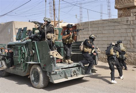 Members Of The Iraqi Special Forces Take Positions During A Patrol In