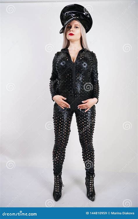 Cruel Fashionable Bdsm Lady With Curves Dressed In Black Catsuit With Holes And Posing On A