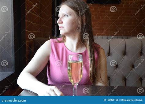 Beautiful Blond Girl Holding A Glass Of Champagne Or Wine Drinking