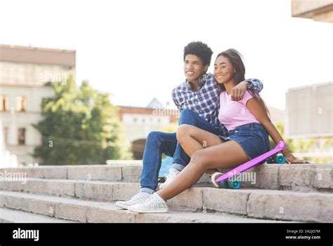 Couple Of Teenagers Sitting On Stairs Outdoors Stock Photo Alamy