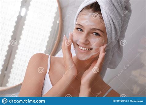 Beautiful Teenage Girl Applying Cleansing Foam Onto Face In Bathroom Skin Care Cosmetic Stock