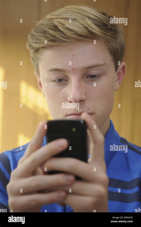 Teenage Boy Using A Mobile Phone Stock Photo Alamy