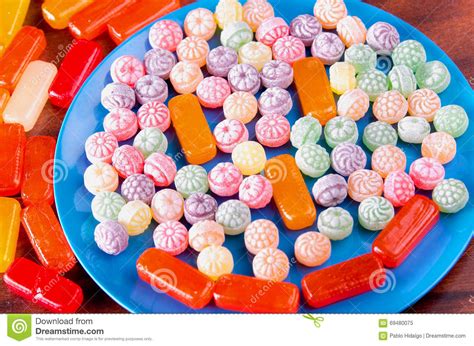 Variation Of Colorful Hard Candy Lying On Blue Plate Stock Image
