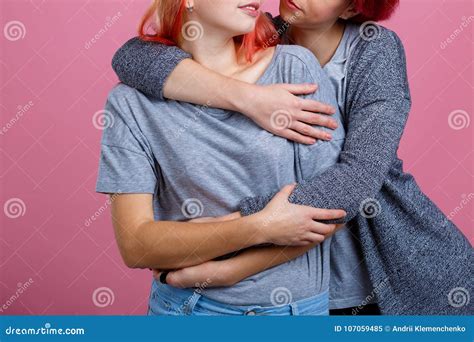 Embraces Of Two Young Lesbian Girls On A Pink Background Stock Image