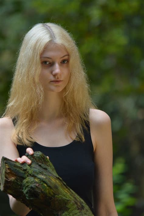 free photo woman in black tank top while her right hand is holding a tree branch beautiful