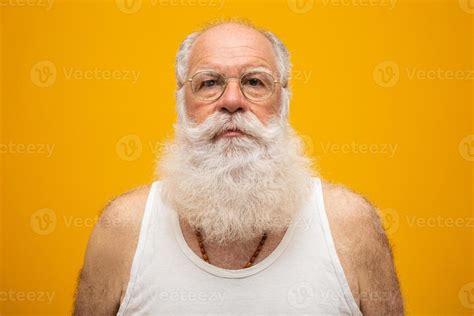 old man with a long beard on a yellow background senior with full white beard old man with a