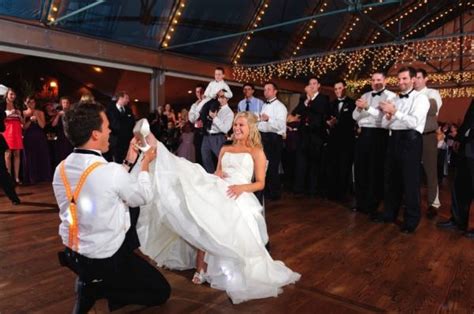 During the reception, the bride sits in a chair while her groom removes a garter from around her leg. Wedding Garter Traditions That You Need To Know!!