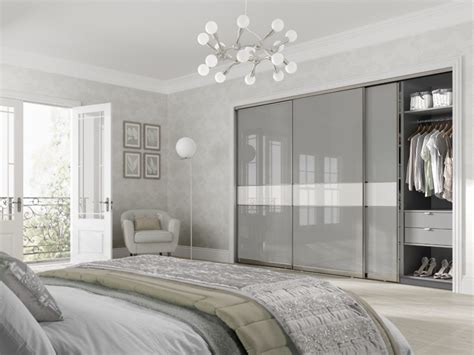 Softly curved aluminium frames with wood effect panels & mirror door options for a modern bedroom. Sliding Wardrobes - Sliding Door Wardrobes - Made to ...