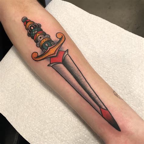 my first tattoo american traditional dagger done by zach at black moon tattoo in madison wi r