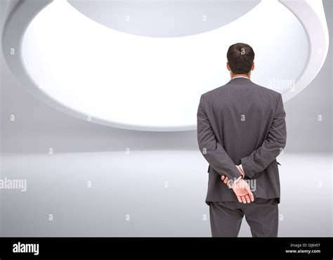 Businessman Standing With Hands Behind Back Stock Photo Alamy