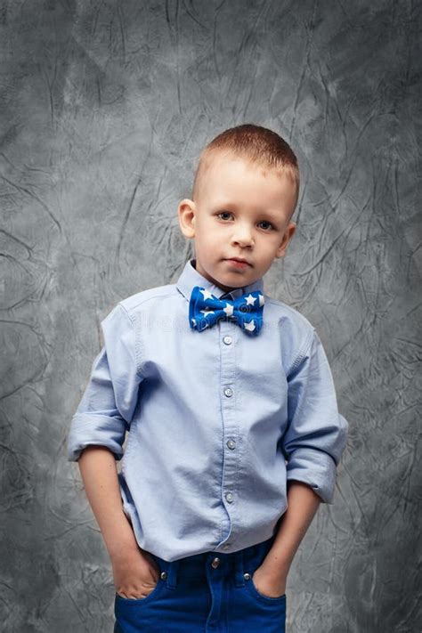Portrait Of A Cute Little Boy In Jeans Blue Shirt And Bow Tie Stock