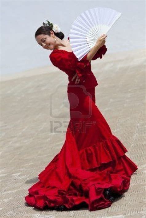 Woman Traditional Spanish Flamenco Dancer Dancing In A Red Dress With A White Fan Flamenco