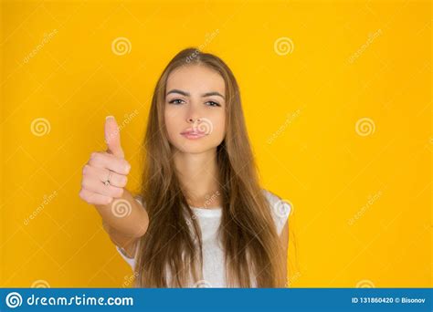 Portrait Of The Beautiful Young Woman On The Yellow Background Stock