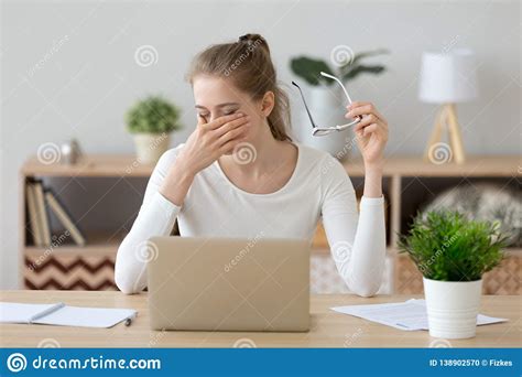 Tired Woman Rubbing Eyes Taking Off Glasses After Computer Work Stock