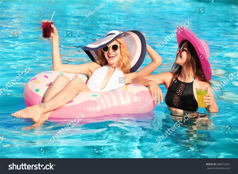 Beautiful Women Cocktails Relaxing Pool Stock Photo