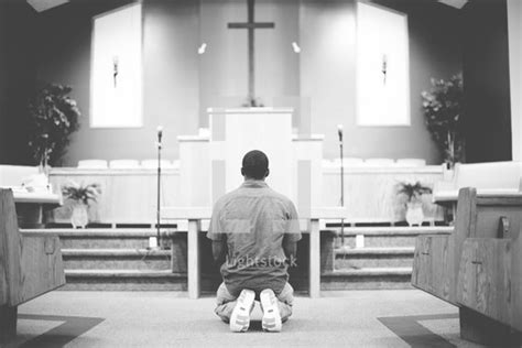 A Man Kneeling In Front Of An Altar — Photo — Lightstock