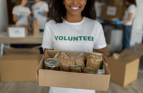 Humanitarian Aid Black Female Volunteer Holding Food Donation Box And